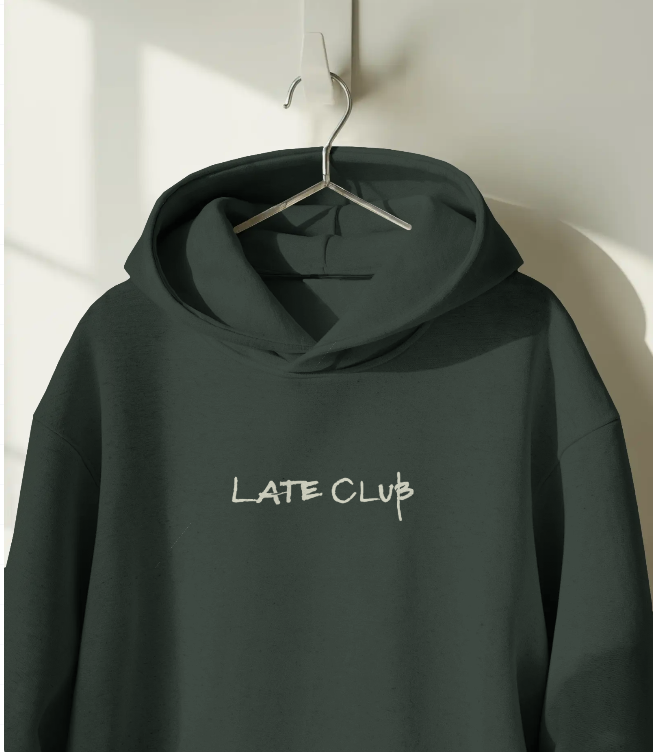 Dark green hoodie with 'LATE CLUB' text on a hanger against a light background